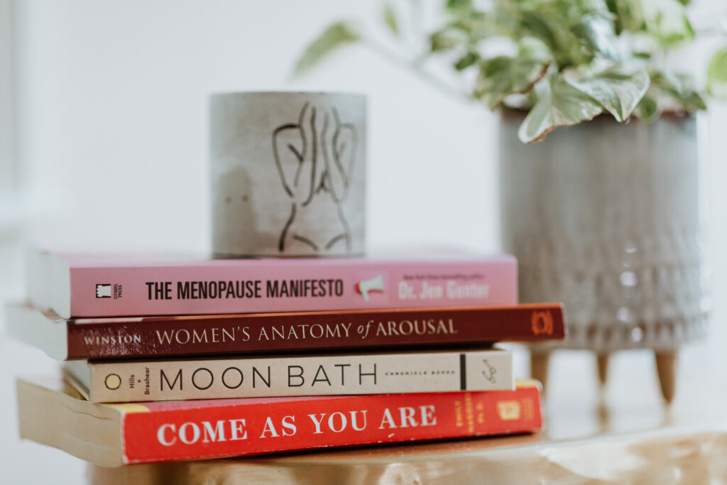stack of healing and wellness books