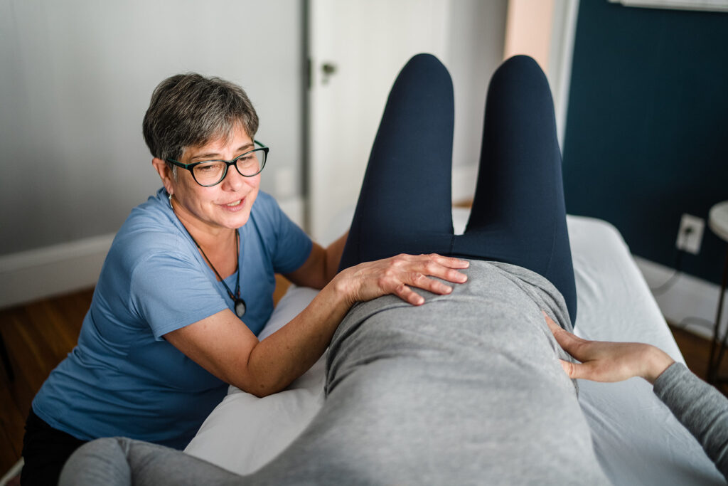 physical therapist working with a expectant mom