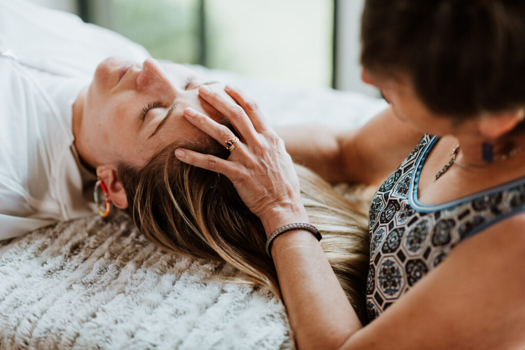 healer holding hand over woman's head