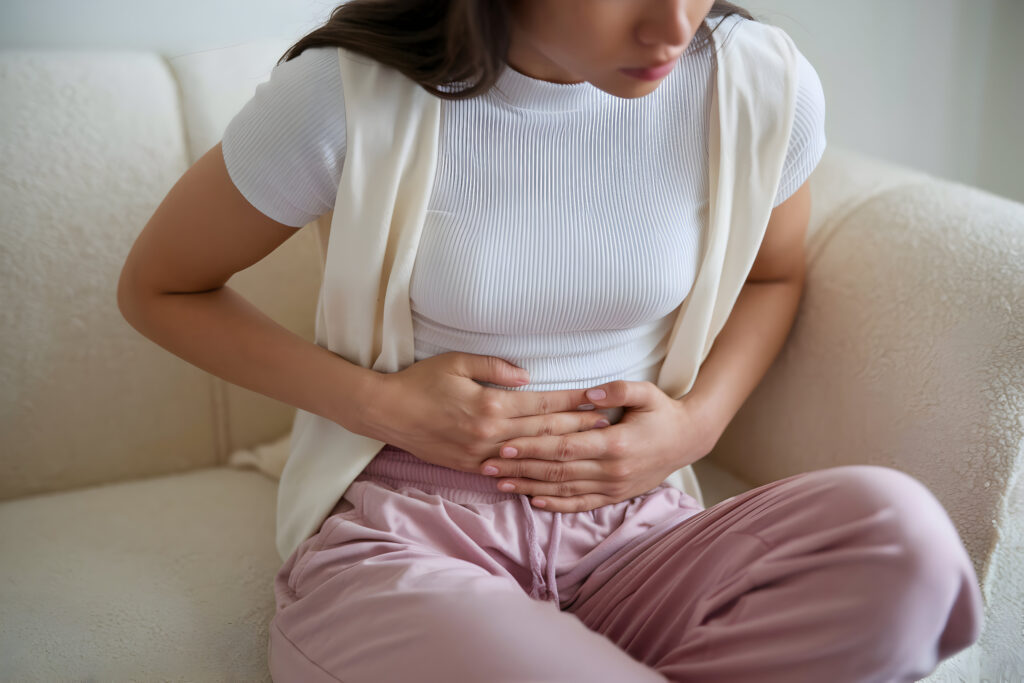 Woman struggling with upper abdominal pain postpartum