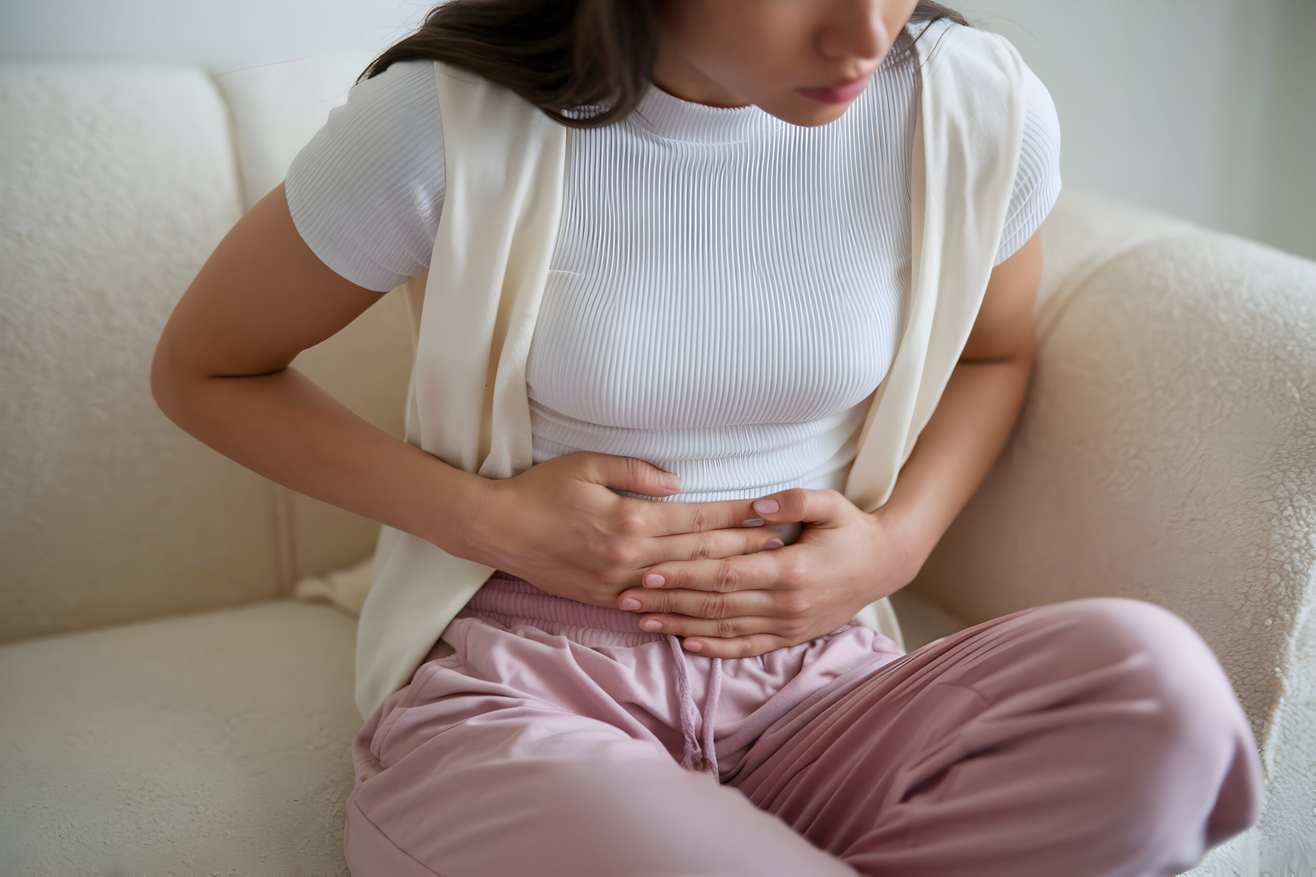 Woman struggling with upper abdominal pain postpartum